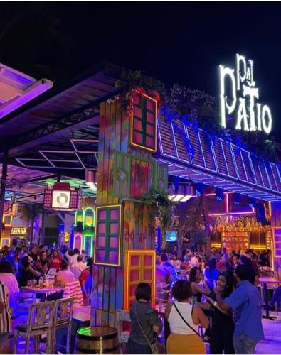 a crowd of people sitting at a bar at night at Downtown Punta Cana Vibrant Apartment! in Punta Cana