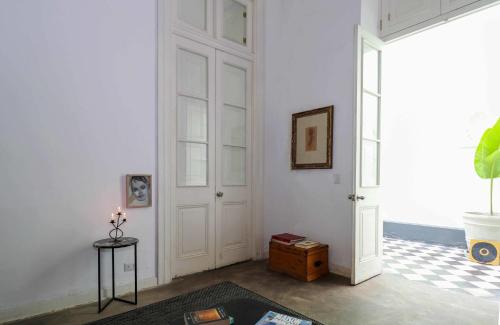 a living room with a white door and a table at Bohemian Villa in heart of Barranco in Lima