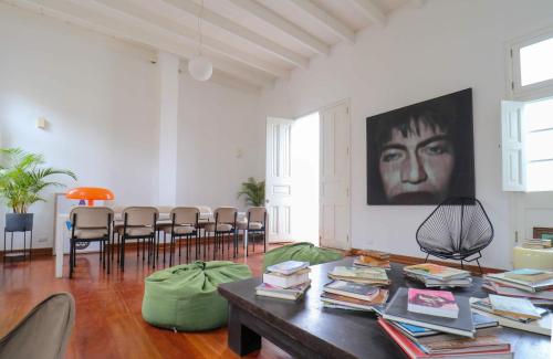 a living room with a table with books at Bohemian Villa in heart of Barranco in Lima
