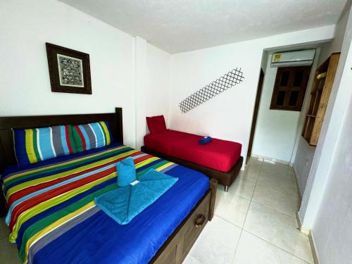 a bedroom with a bed with a blue star on it at Hostal Nibuni Palomino in Palomino