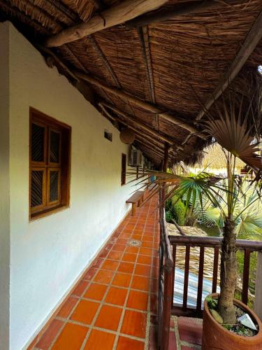 a porch of a house with a brick walkway at Hostal Nibuni Palomino in Palomino