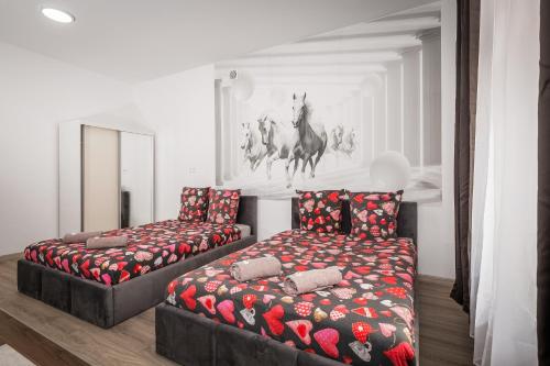 a living room with two beds and a chair at 70s Guest room in Kraków