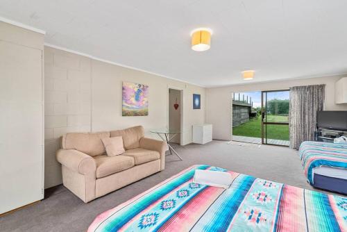a living room with a couch and a bed at MTB Paradise in Rotorua