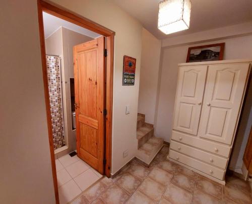 a hallway with a door and stairs in a house at La Querencia de Buenos Aires in Buenos Aires