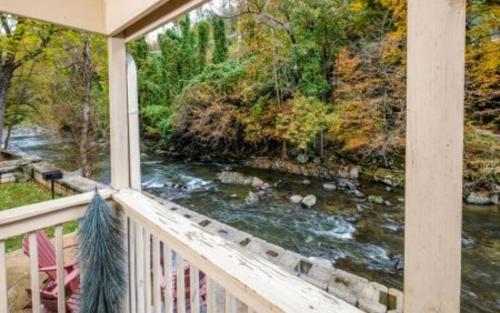a view of a river from a porch at Simones Cottage in Gatlinburg