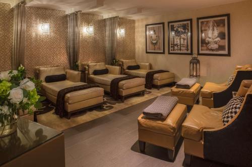 a waiting room with couches and chairs in a salon at The Roosevelt Hotel New Orleans - Waldorf Astoria Hotels & Resorts in New Orleans