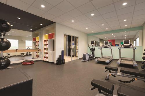 a gym with treadmills and ellipticals in a room at Tru By Hilton Lancaster East in Lancaster