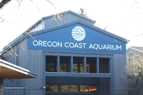 a building with the ocean coast aquarium on it at Little Creek Cove Beach Resort in Newport