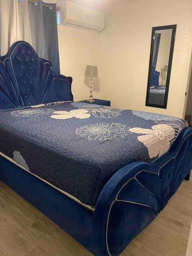 a blue bed with a blue comforter on it at Villa New Place in Las Vegas