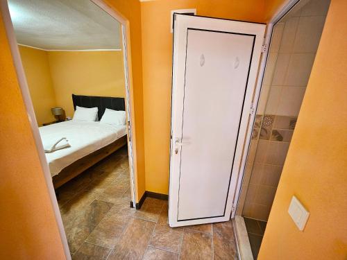 a small bedroom with a bed and a mirror at Alen Mak Forest Hotel in Lipnik