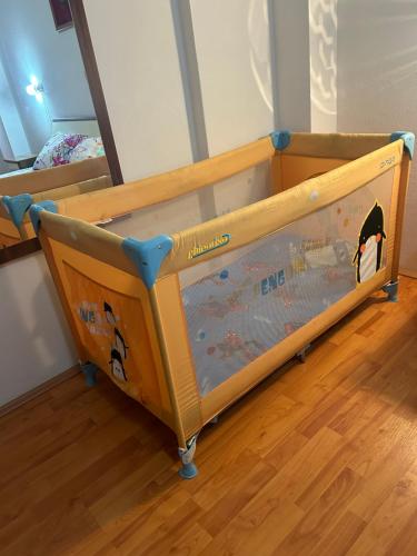 a toddler bed with a wooden frame in a room at Mario in Ohrid