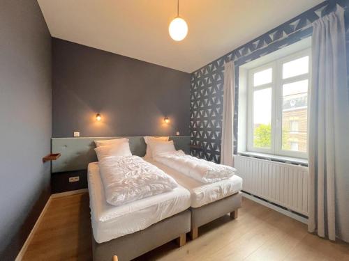 a bedroom with a bed and a window at Achter de Hegge in Riemst