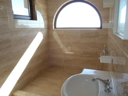 a bathroom with a sink and a window at Cloudbase Guesthouse in Sopot
