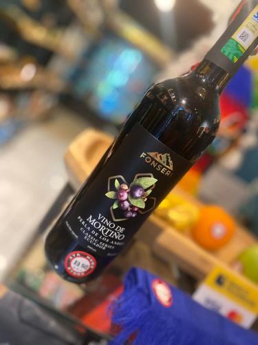 a bottle of wine sitting on top of a refrigerator at Hostal La Guayunga RoofTop in Quito