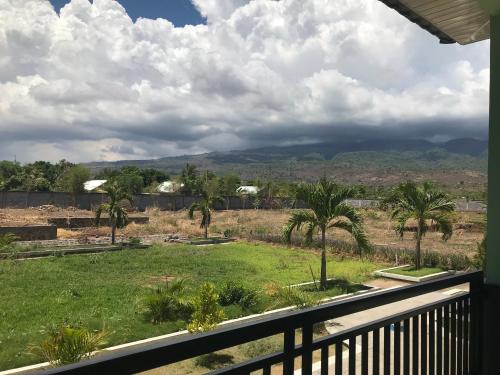 a view from a balcony of a yard with palm trees at Pohon Purba Resort & Restaurant in Labuan Lombok
