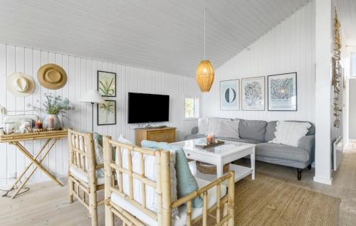 a living room with a couch and a tv at Holiday Home Ballesvej in Sillerslev
