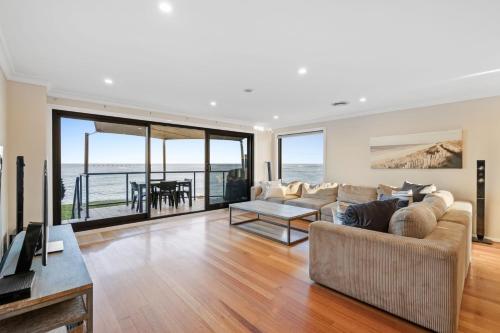 a living room with a view of the ocean at Seaside Haven on Hutton Road in The Entrance