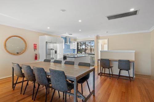 a kitchen and dining room with a table and chairs at Seaside Haven on Hutton Road in The Entrance