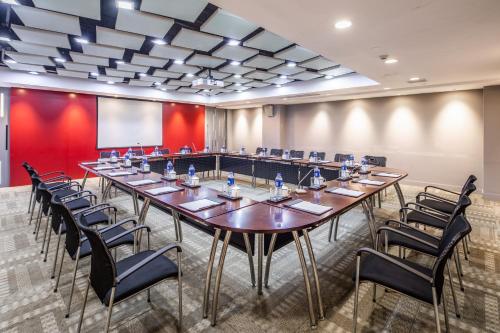 a large conference room with a long table and chairs at Mason Hotel in Shanghai