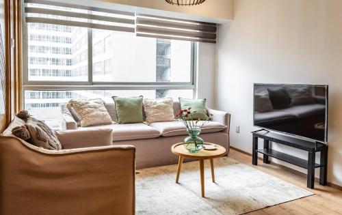 a living room with a couch and a table at Cozy & Stylish apartmen @ New Polanco 3bed/2.5bath in Mexico City