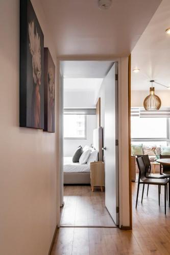 a hallway leading to a bedroom with a bed at Cozy & Stylish apartmen @ New Polanco 3bed/2.5bath in Mexico City