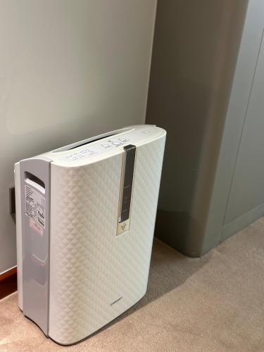 a microwave sitting on the floor next to a wall at Mason Hotel in Shanghai