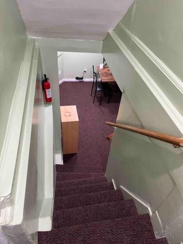 a stairway with a fire hydrant and a table in a room at 1 Bedroom Basement, NEWLY Renovated in Bellerose Terrace
