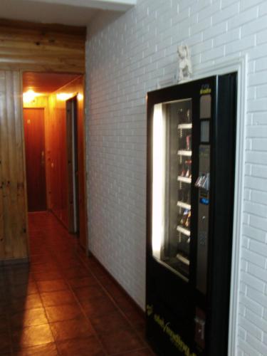 a vending machine is next to a brick wall at Hostal La Torre in Santander