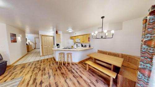 a kitchen with a table and a bench in a room at The Rock #3461 in Moab