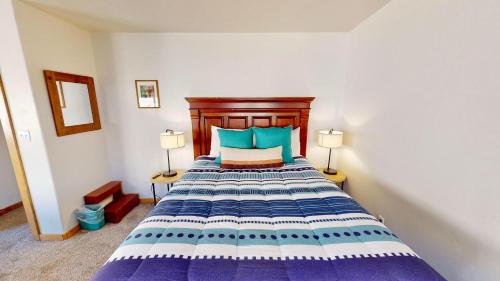 a bedroom with a large bed with two lamps at The Rock #3461 in Moab