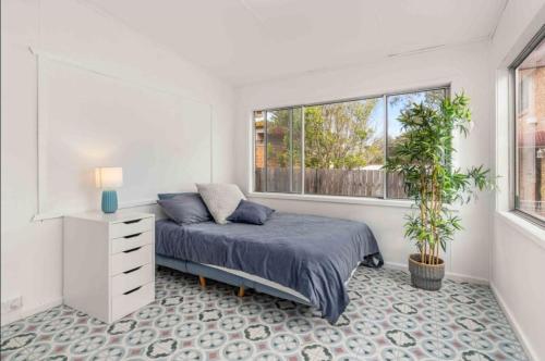 a bedroom with a bed and a window at Sea Breeze Escape - Pet-Friendly Escape - Book 3, Pay for 2! in Greenwell Point