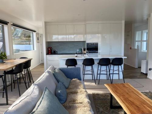 a living room and kitchen with a couch and a table at Wynter Apartments in Queenstown