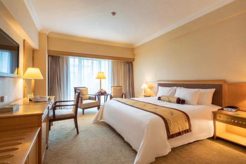 a hotel room with a large bed and a desk at Mason Hotel in Shanghai