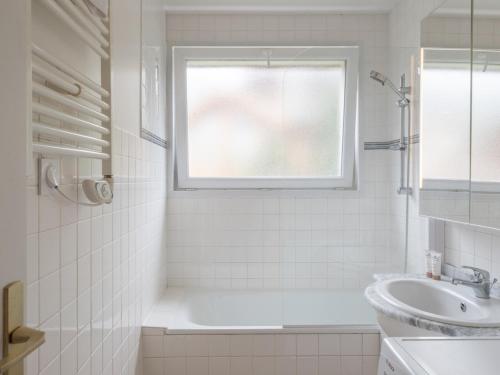 a white bathroom with a sink and a window at Appartement familial au centre avec balcon et WiFi - FR-1-645-75 in LʼHuez