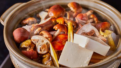 a bucket of food with mushrooms and other foods at Tengu Onsen Asama Sanso in Komoro