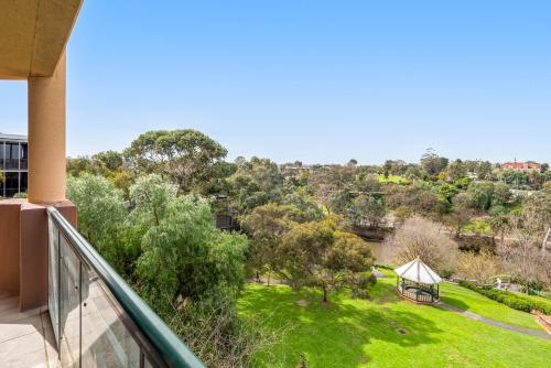 a balcony of a house with a view of a park at Amora Hotel Riverwalk Melbourne in Melbourne