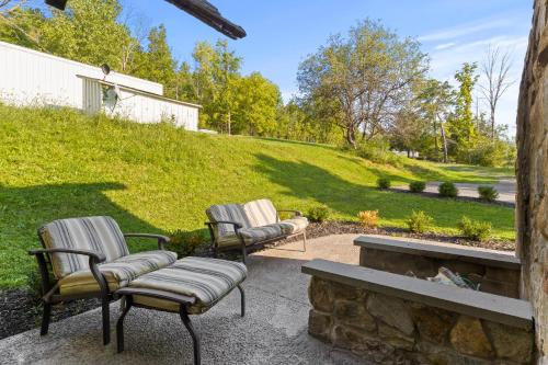 two chairs and a fire place in a yard at Cozy Two Bedroom Home On Canandaigua Lake in Rushville
