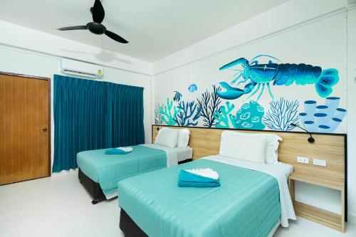 a room with two beds and an aquarium mural at Touch Sea Boutique Hotel&Bistro in Karon Beach