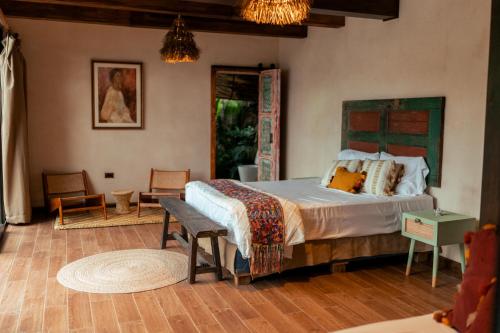 a bedroom with a large bed in a room at Baba Yaga Atitlan in San Marcos La Laguna