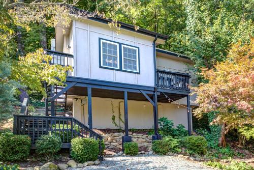 a large house with a balcony and trees at The Zen Den Peaceful Cottage with Mountain Views in Banner Elk