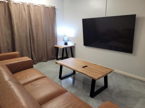 a living room with a couch and a coffee table at Paradise Holiday Apartments in Cairns