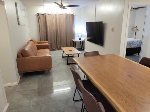 a living room with a couch and a table at Paradise Holiday Apartments in Cairns