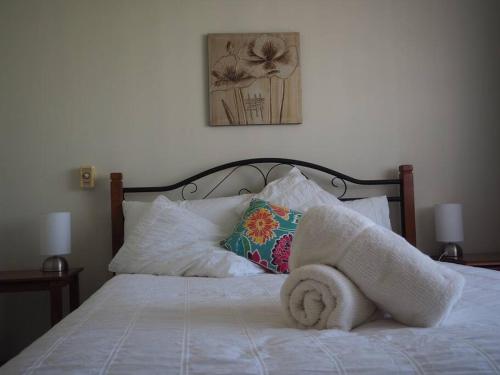 a bed with a towel on top of it at Mandurah Island Retreat in Wannanup