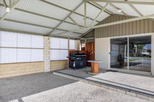 a screened in porch of a house with a grill at Mandurah Island Retreat in Wannanup