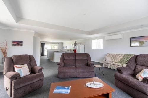 a living room with two chairs and a table at Mandurah Island Retreat in Wannanup