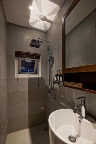 a bathroom with a sink and a mirror at Nexus House Nguyen Binh Khiem - Near Saigon Zoo & Botanical Gardens in Ho Chi Minh City