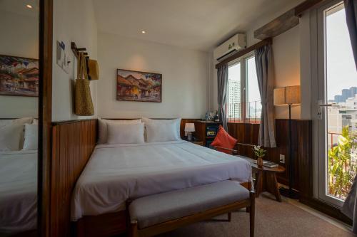 a hotel room with a bed and a window at Nexus House Nguyen Binh Khiem - Near Saigon Zoo & Botanical Gardens in Ho Chi Minh City