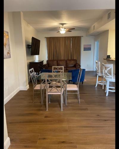 a dining room and living room with a table and chairs at Blue Harbour in Riviera Beach