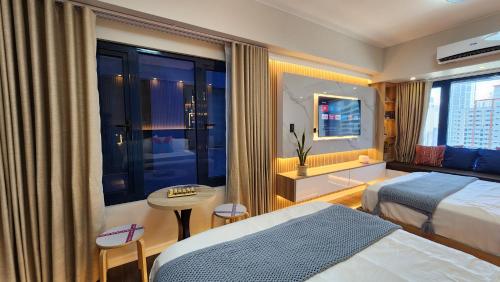 a hotel room with a bed and a window at Makati Air Luxury Package - Laugh Sleep Brunch Surf 300 mbps Fast in Manila