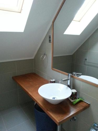 a bathroom with a sink and a mirror at Casa Tipo Town House in Pucón